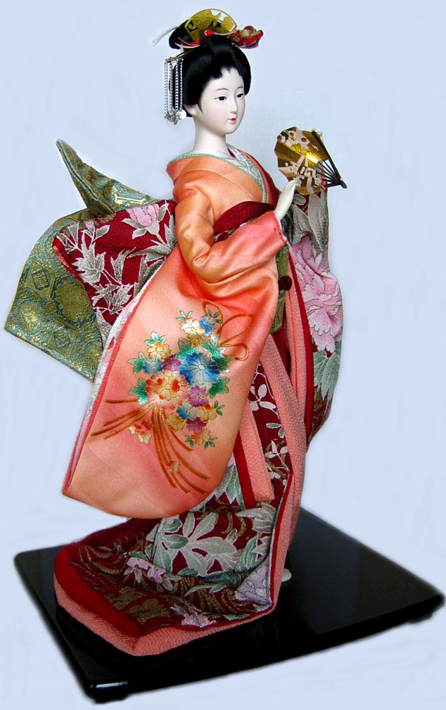 japanese traditional doll of a young lady dancing with folding fan in her hands
