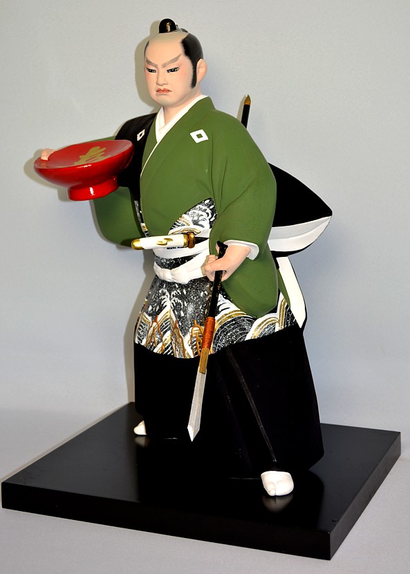 japanese traditional ceramic figurine of a samurai warrior with spear and loving cup