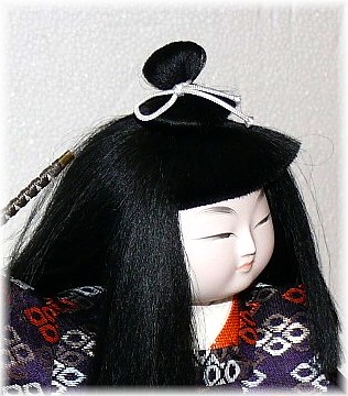 japanese traditional doll of a young samurai with sword