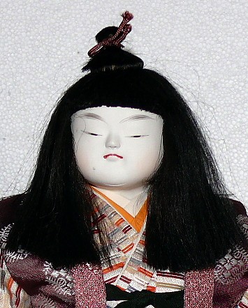 japanese antique doll of a young samurai with tachi sword in his hand
