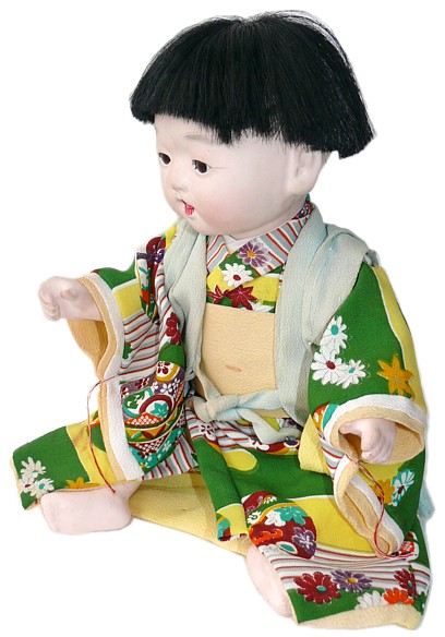 japanese antique doll of a child in green kimono, 1930's 