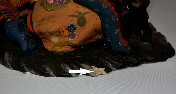 hakata clay doll of a samurai warrior: detail of missing part on bearskin