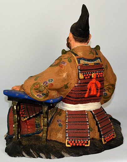 Shogun, sitting on bearskin, Japanese Hakata clay doll, 1950's