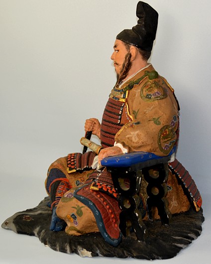 Shogun, sitting on bearskin, Japanese Hakata clay doll, 1950's