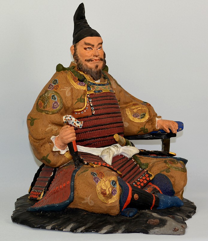 samurai warrior lord sitting on bearskin rug, Japanese hakata doll