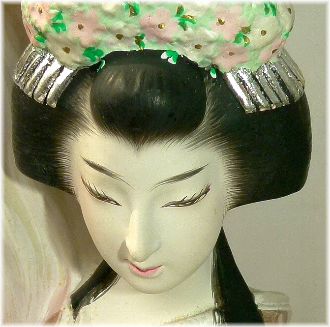japanese clay figurine of Princess with war helmet in her hands