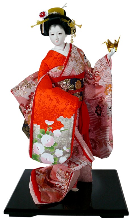 Japanese traditional doll of a young girl with origami in her hand ...